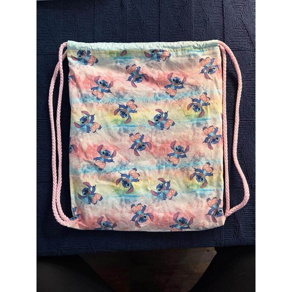 Handmade Lilo &Stitch drawstring bag on tie-dye fabric.